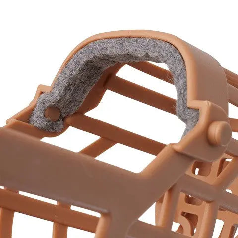 Brown pet muzzle with a soft padded interior for comfort and secure fit.
