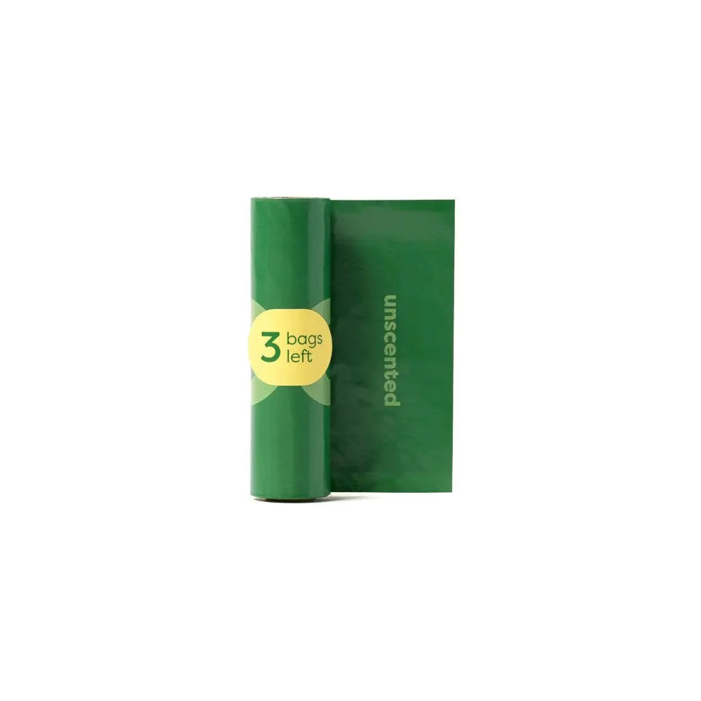 Green unscented trash bags roll with three bags remaining, ideal for eco-friendly waste disposal.