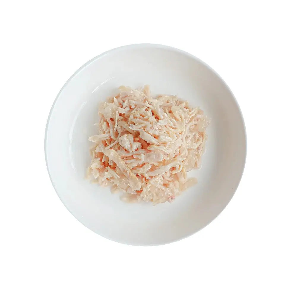 Creamy shredded chicken salad served in a white bowl, perfect for a light meal or sandwich filling.