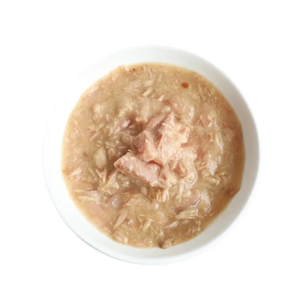 Bowl of creamy cat food with chunks of fish and rice, perfect for a nutritious meal.