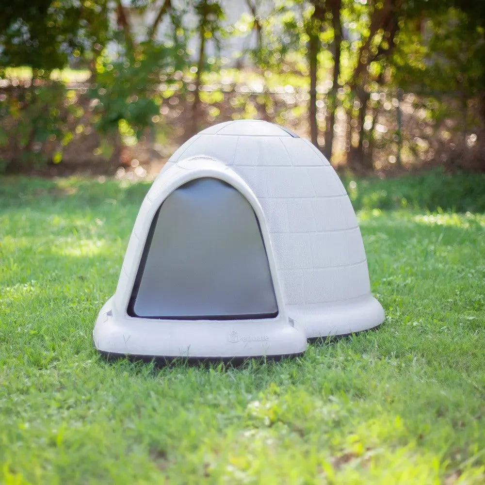 Durable outdoor dog house with igloo design, perfect for keeping pets comfortable in any weather.