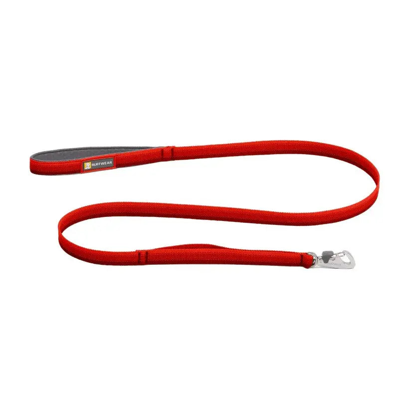 Red dog leash with a sturdy clip and comfortable grip for safe walks.
