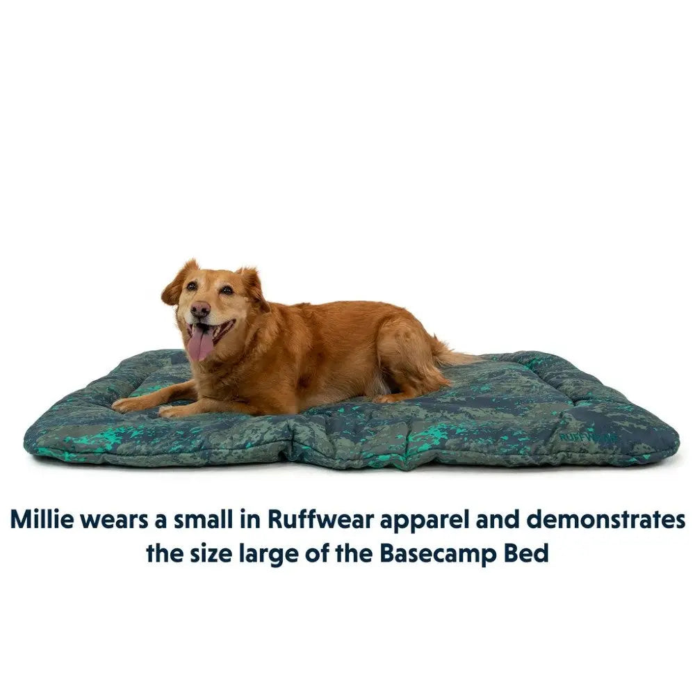 Golden retriever on a large Basecamp Bed, showcasing Ruffwear apparel in a cozy setting.