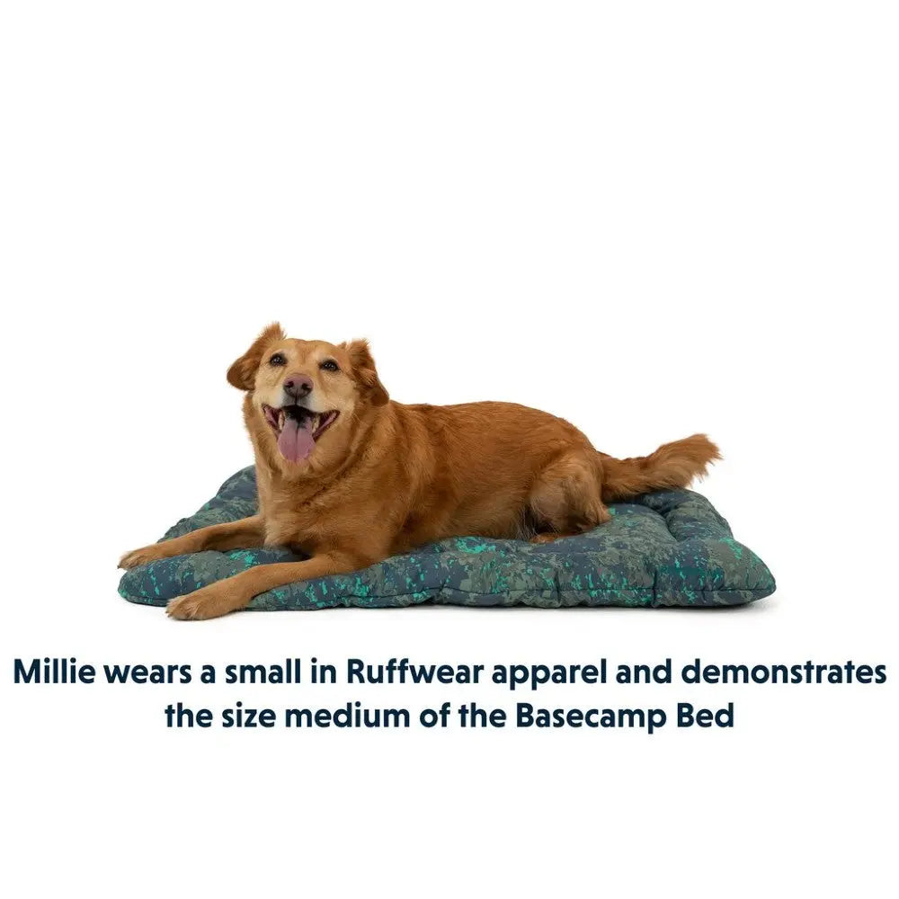 Golden retriever on a cozy Basecamp Bed, showcasing Ruffwear apparel in a medium size.