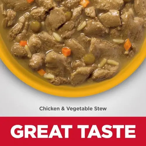 Chicken and vegetable stew in a yellow bowl, showcasing hearty ingredients and great taste.