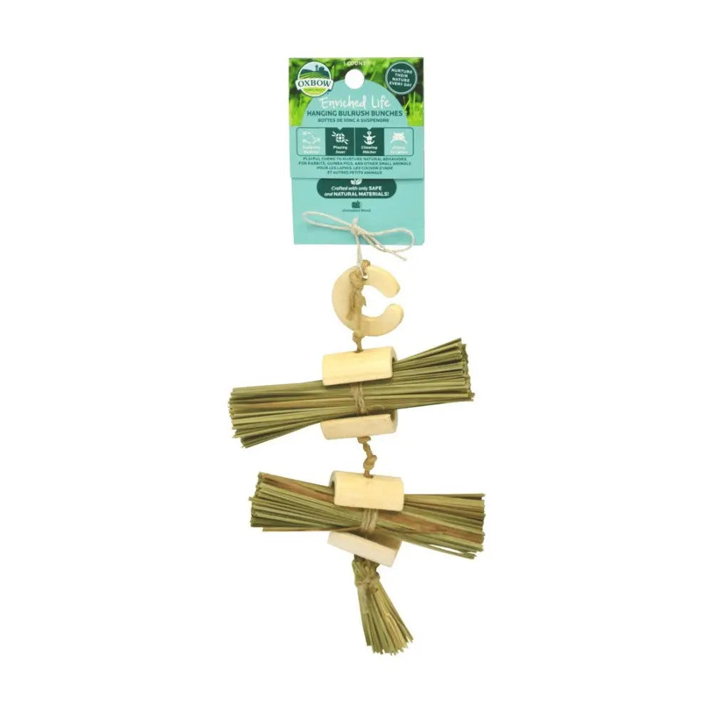 Hanging chew toy for small animals made of natural grass and bamboo, promoting dental health and enrichment.