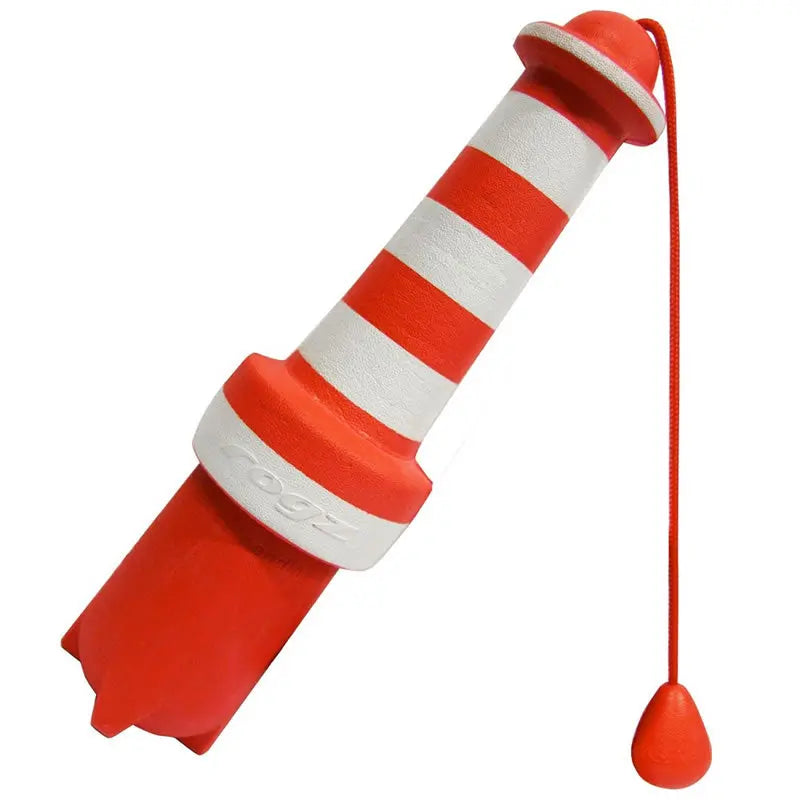 Red and white striped buoy toy for dogs, perfect for outdoor play and fetch activities.