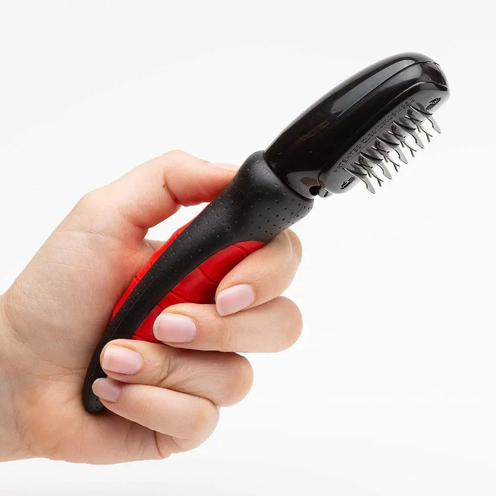 Pet grooming brush with ergonomic handle for effective fur removal and detangling.