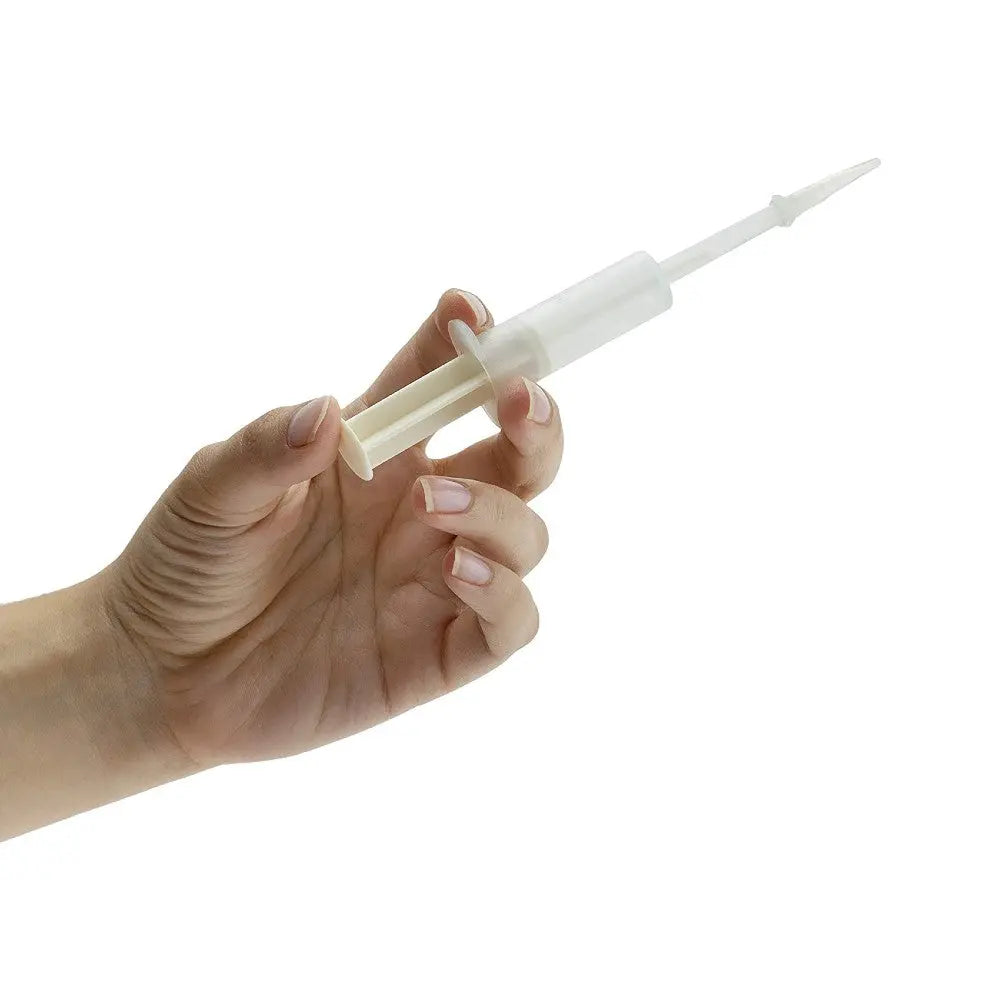 Hand holding a clear plastic syringe for precise liquid measurement and dispensing.