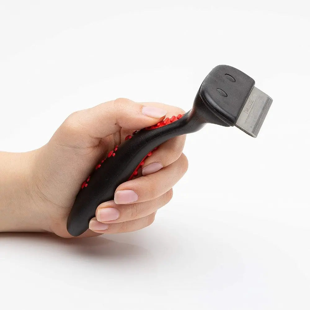 Hand holding a black and red scraper tool with a metal blade for effective cleaning and scraping tasks.