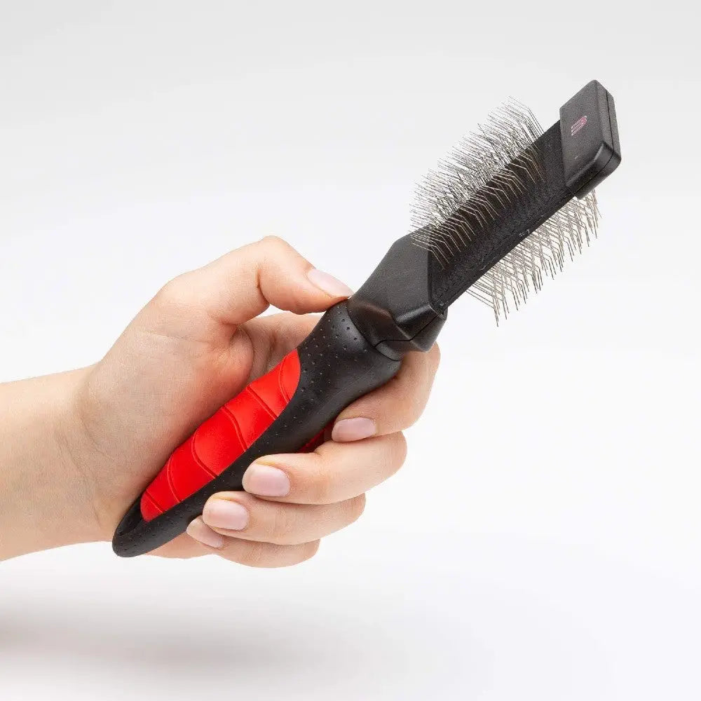 Pet grooming brush with ergonomic handle for effective fur removal and detangling.