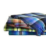 Cozy plaid blankets stacked neatly, perfect for warmth and style in any home decor.