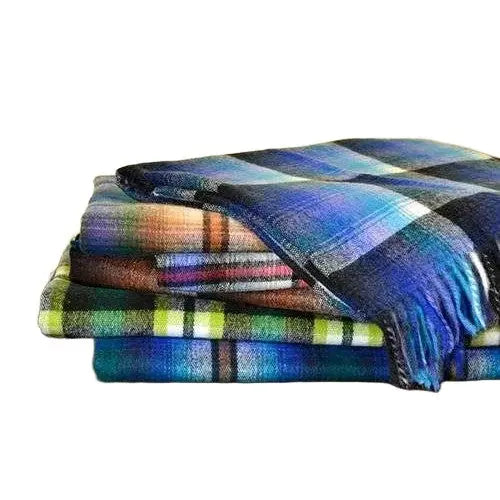 Cozy plaid blankets stacked neatly, perfect for warmth and style in any home decor.