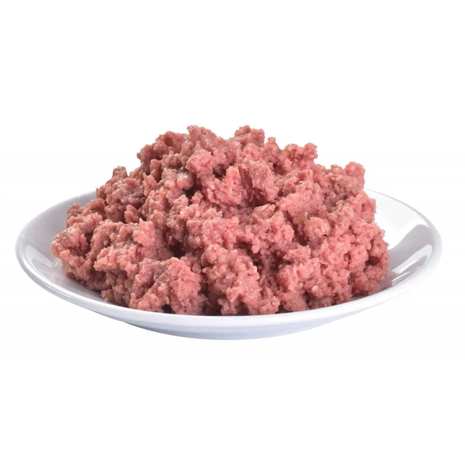 Raw ground meat in a white bowl, perfect for homemade pet food recipes.