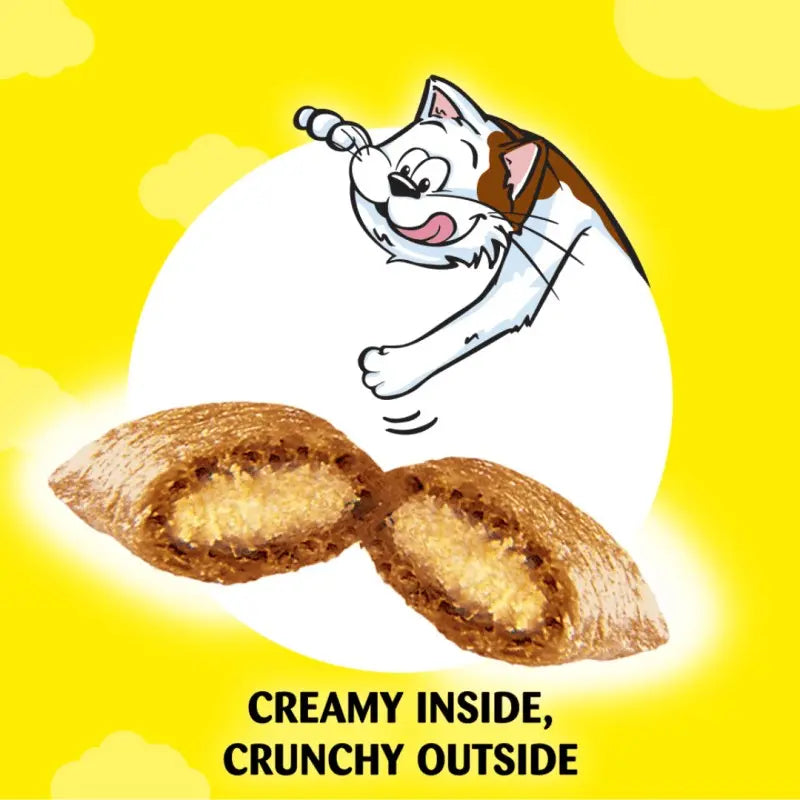 Cat excitedly reaches for a crunchy treat with a creamy filling, highlighted on a bright yellow background.