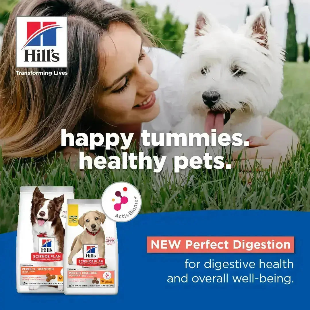 Happy pet owner with dog on grass, promoting Hill's Science Plan for digestive health and well-being.