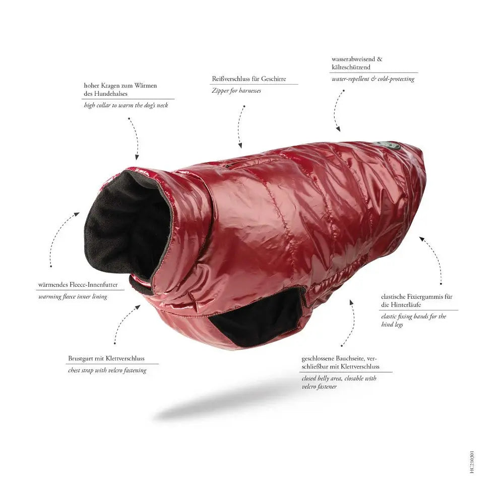 Red insulated dog jacket with fleece lining and waterproof features for cold weather protection.