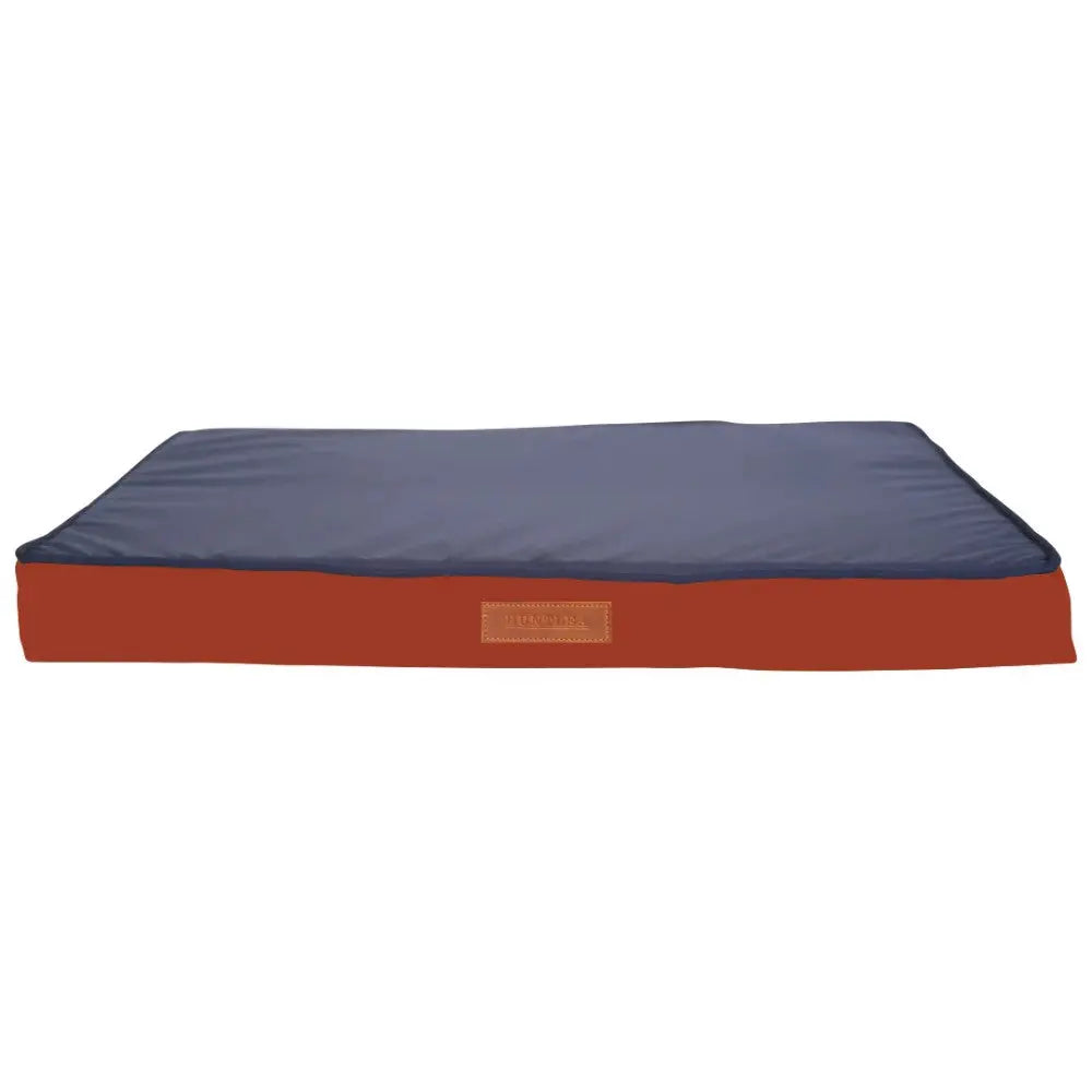 Comfortable dog bed with a navy blue top and durable red base for restful sleep.