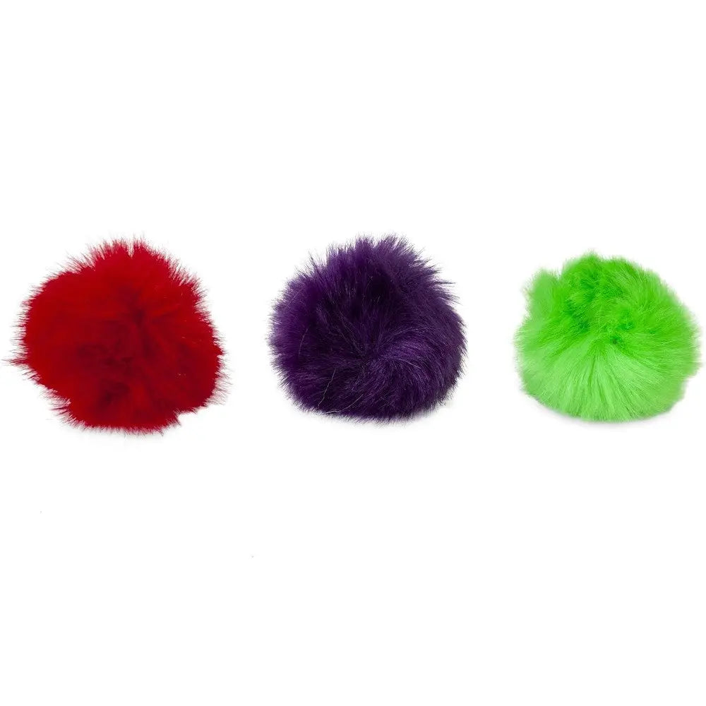 Colorful fluffy pom poms in red, purple, and green for crafting and decoration.