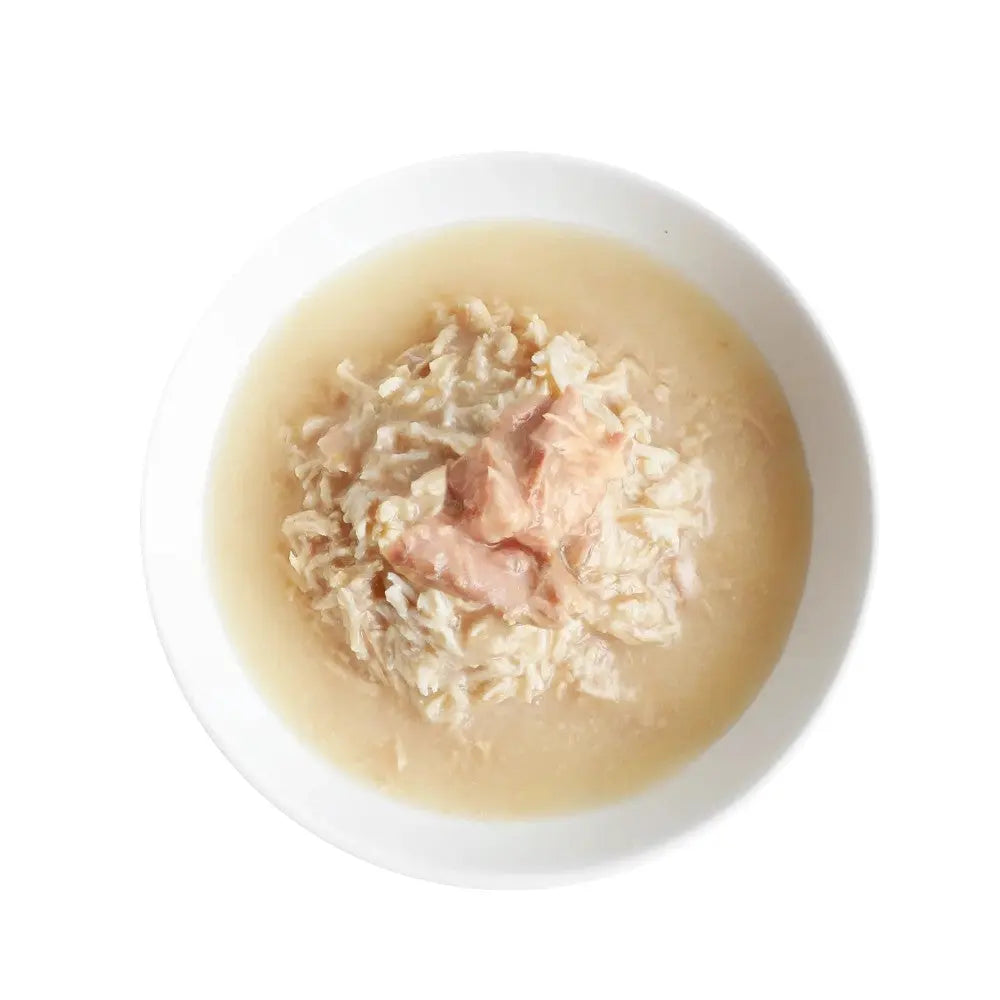 Bowl of chicken and rice soup with tender pieces of chicken and creamy broth.