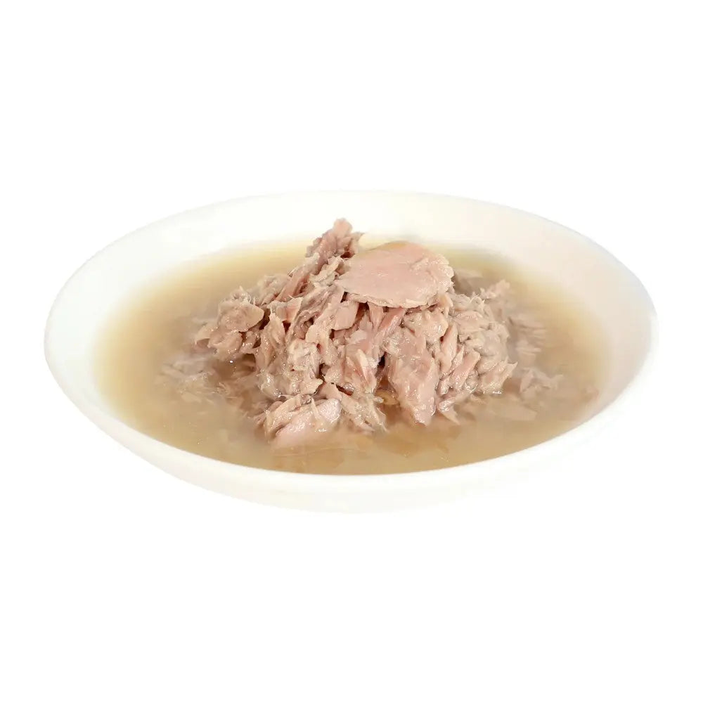 Canned tuna in broth served in a white bowl, perfect for quick meals or recipes.
