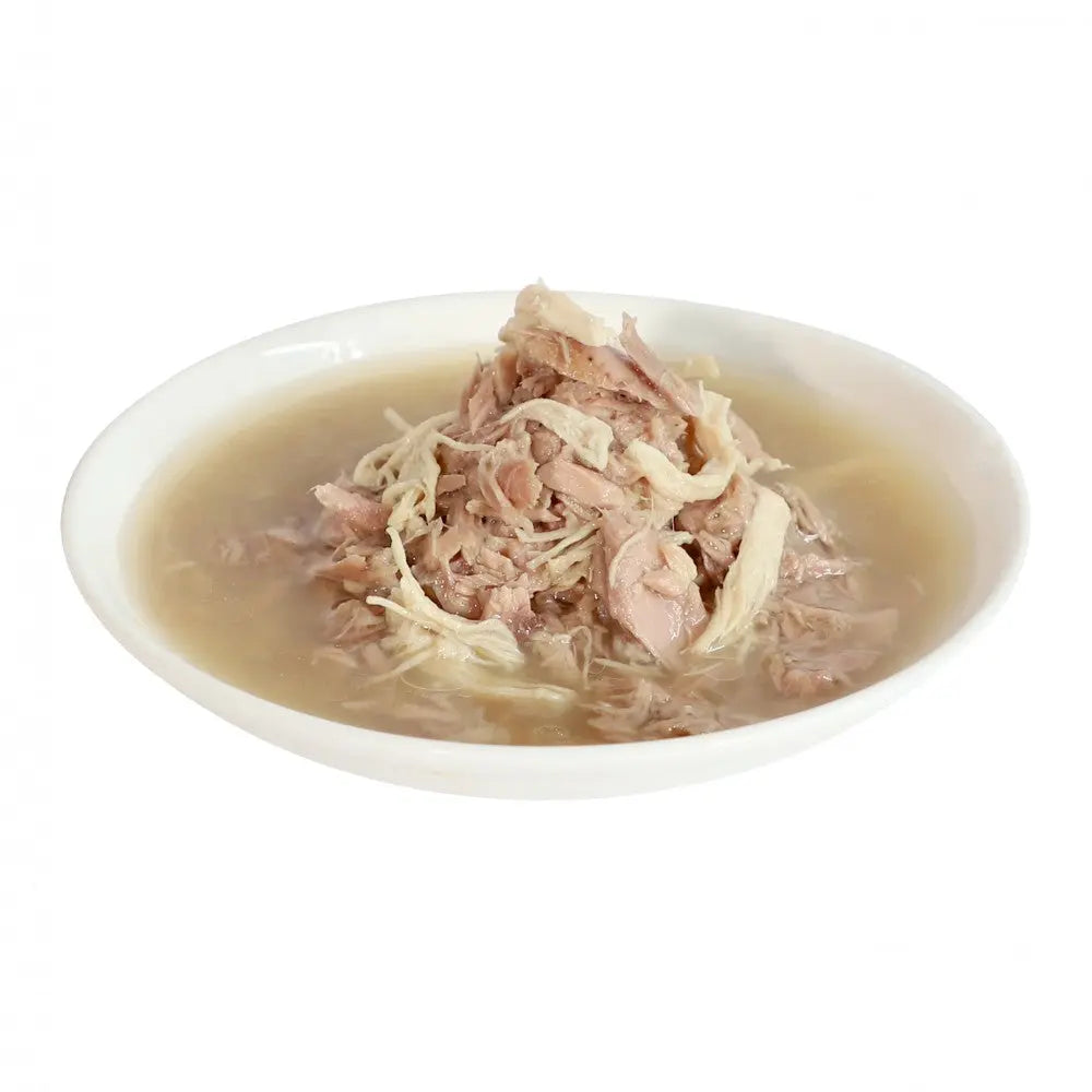 Bowl of savory chicken soup with shredded meat and broth, perfect for a comforting meal.