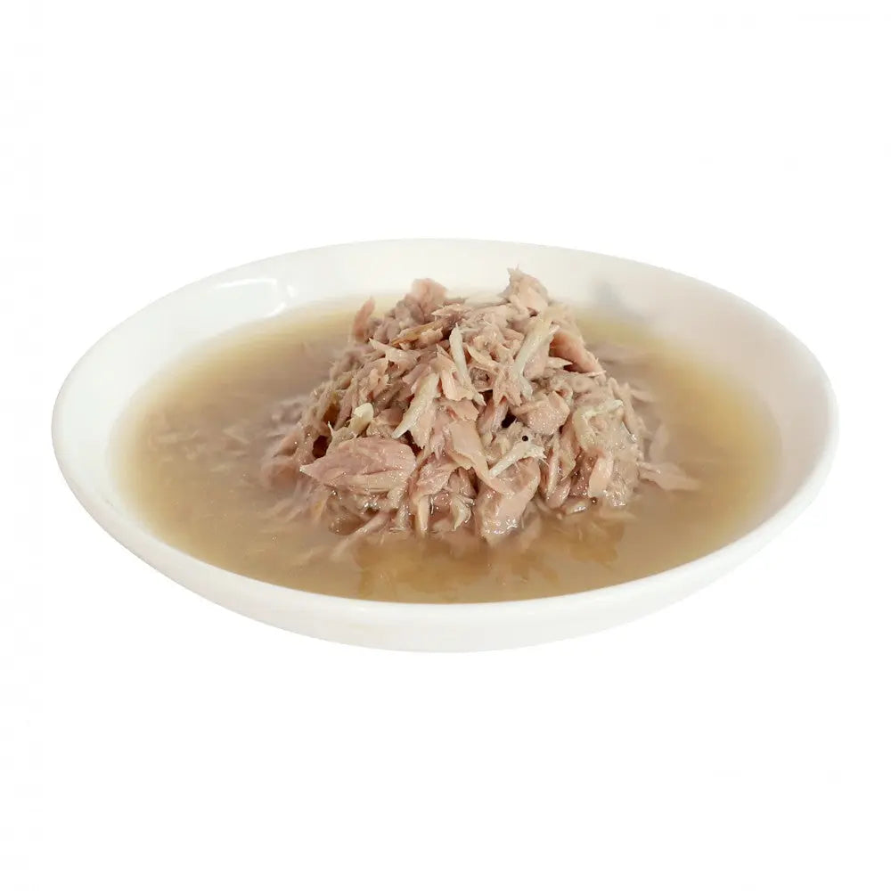 Shredded meat in broth served in a white bowl, perfect for a hearty meal or soup base.