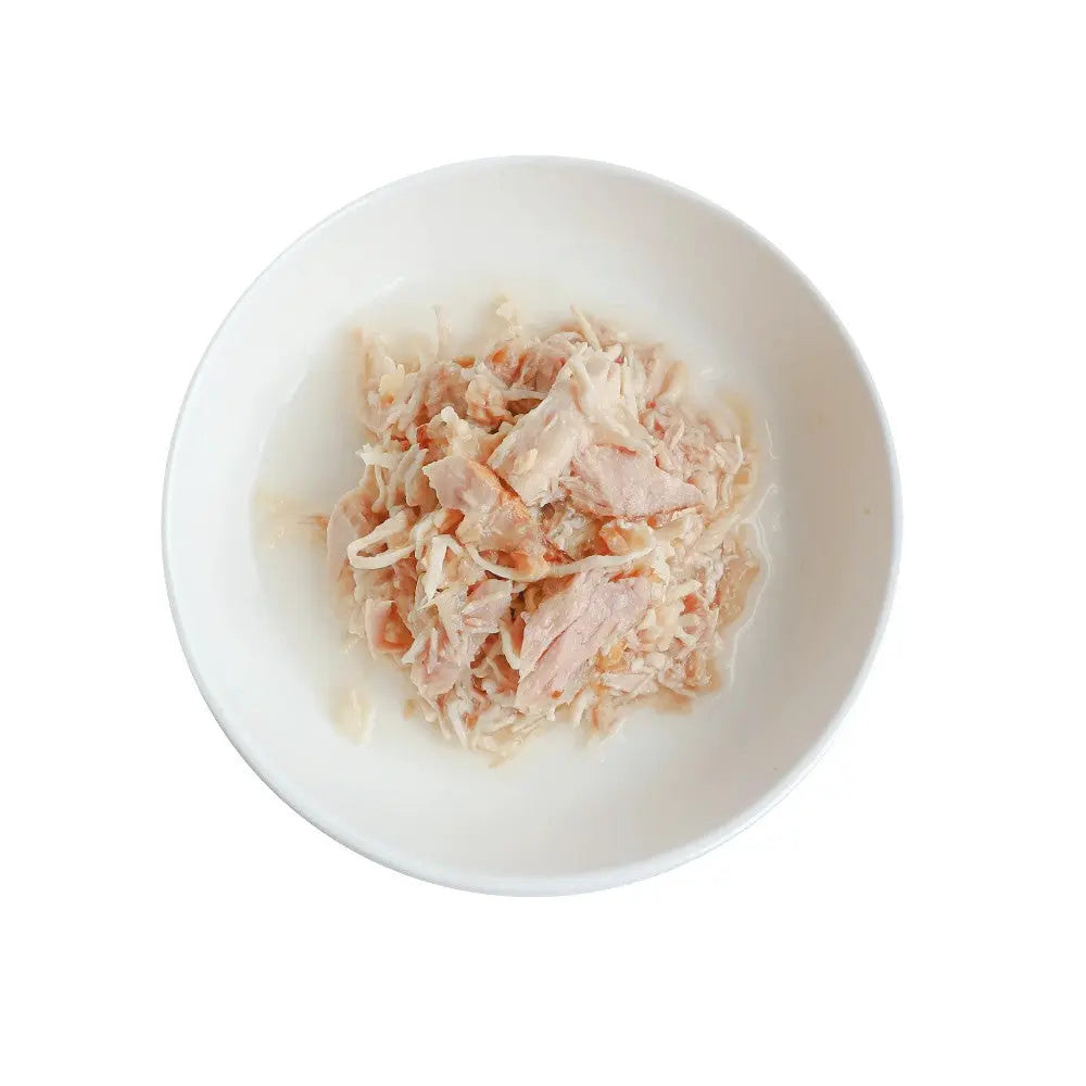 Shredded chicken in a white bowl, perfect for pet meals or homemade recipes.
