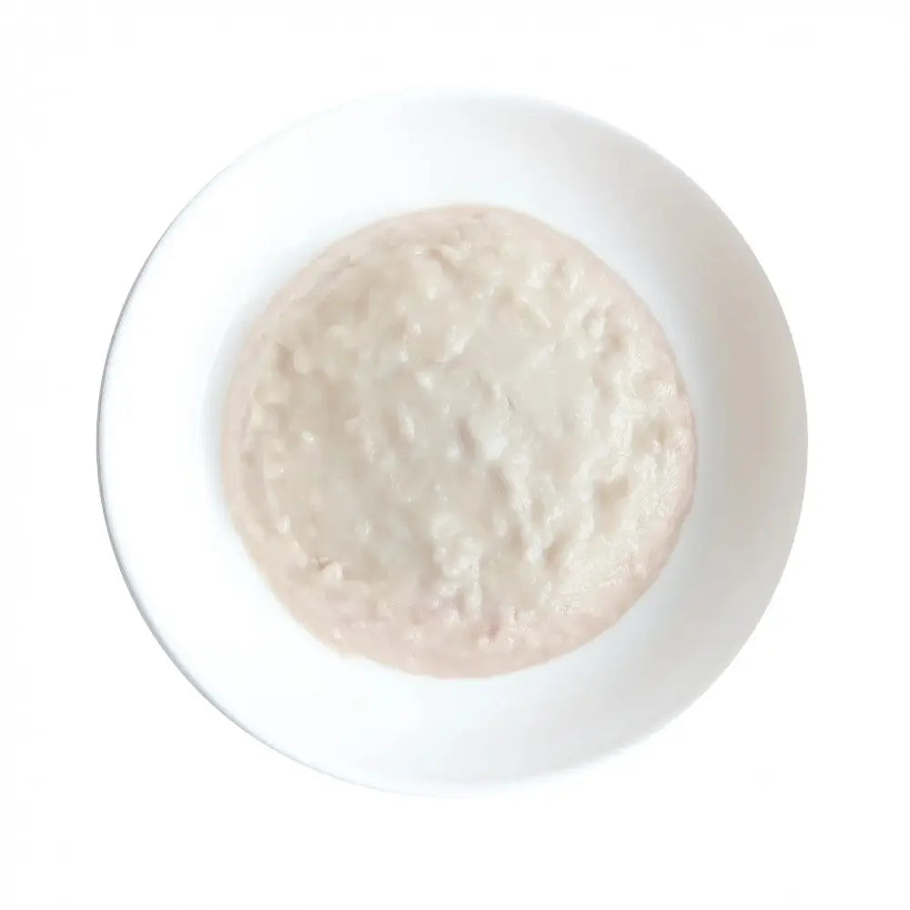 Creamy rice porridge served in a white bowl, perfect for a comforting meal.