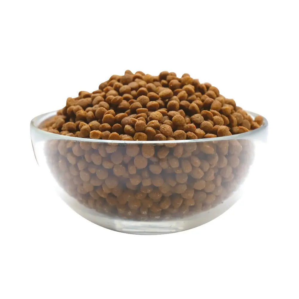 Bowl of dry pet food kibble, showcasing its texture and color for optimal nutrition.