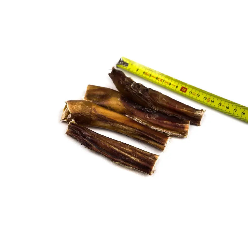 Natural dog chews, beef hide strips, measuring tape for size reference, healthy pet treat option.
