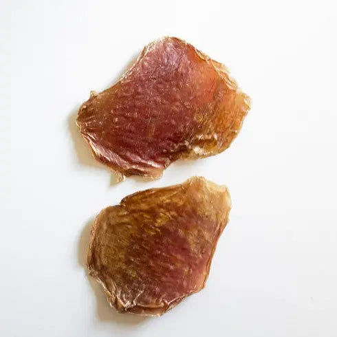 Dried meat slices, perfect for snacks or dog treats, showcasing natural texture and color.