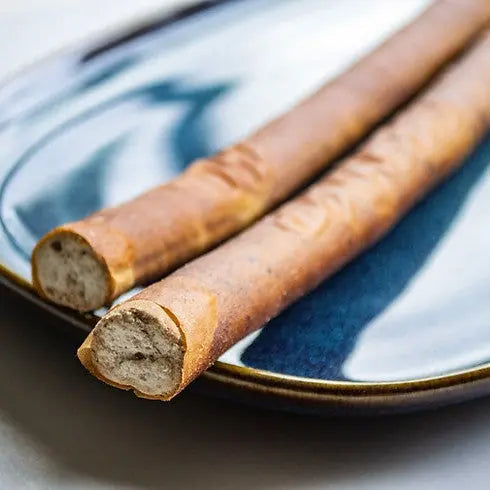 Crispy breadsticks on a blue plate, showcasing a crunchy texture and golden-brown color.