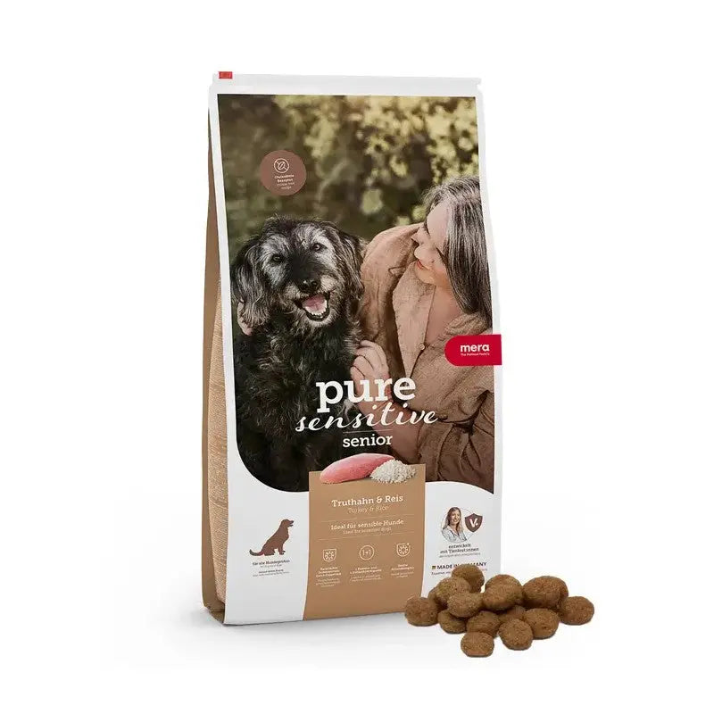Senior dog food bag with natural ingredients, featuring a happy dog and owner.