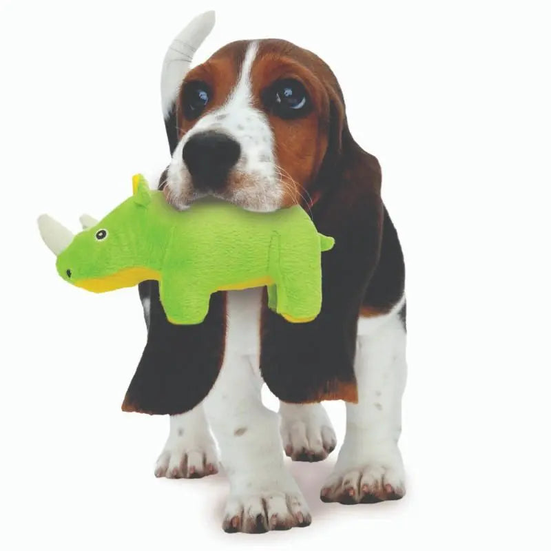 Beagle puppy playing with a green rhino toy, showcasing fun and playful pet moments.