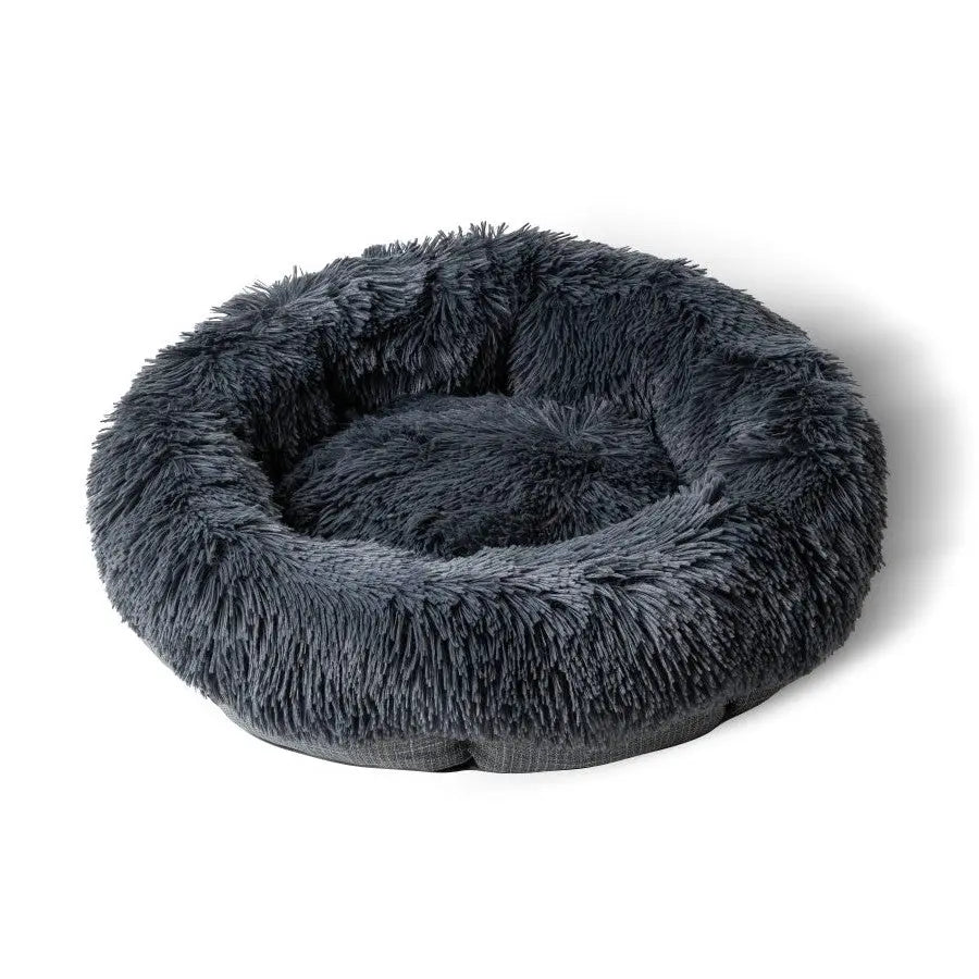 Cozy round pet bed with plush, soft fur for ultimate comfort and relaxation.