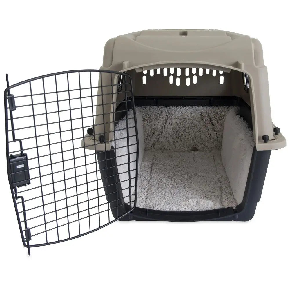 Pet carrier with a cozy interior and a secure metal door for safe travel.