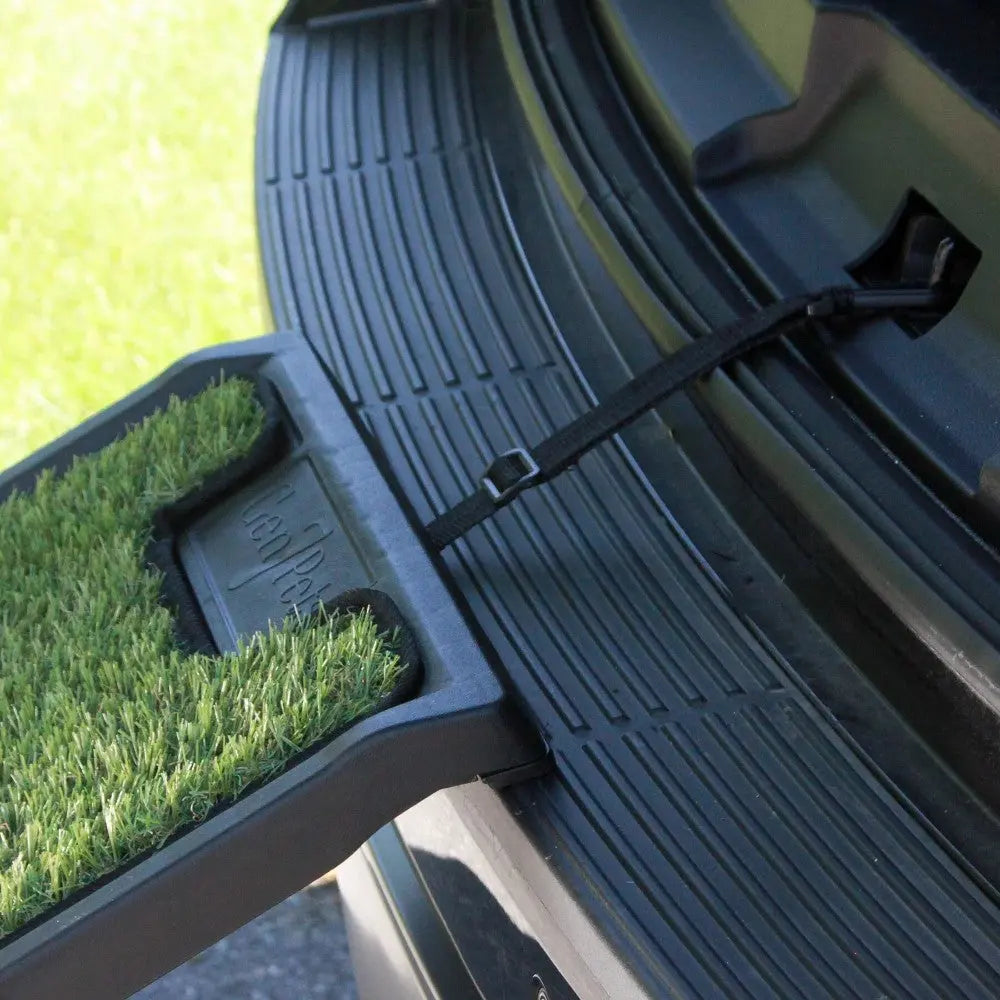 Car trunk mat with artificial grass for easy loading and unloading.