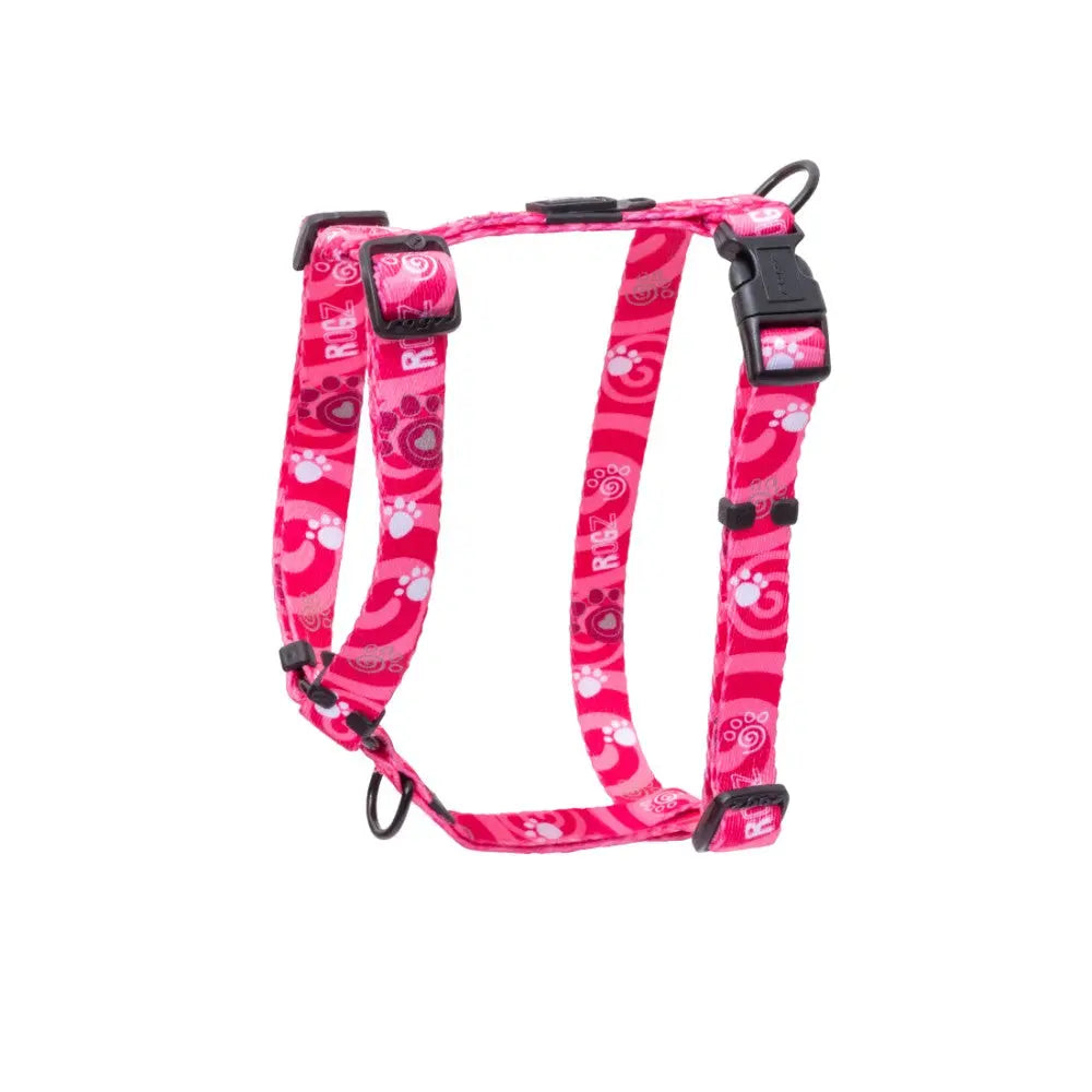 Pink pet harness with playful paw print design, adjustable straps for comfort and safety.