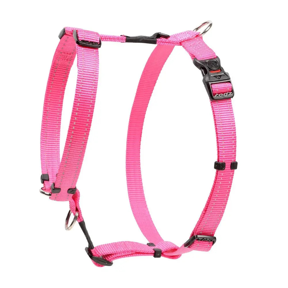 Pink dog harness with adjustable straps and metal D-rings for secure leash attachment.