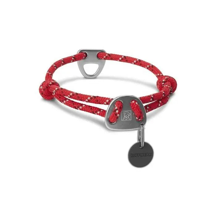 Red rope bracelet with metal clasp and charm, perfect for casual or sporty outfits.