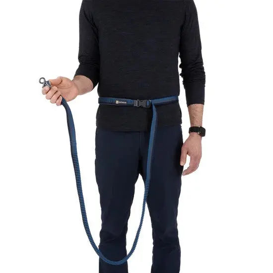 Man holding a hands-free dog leash, ideal for walking or running with pets.