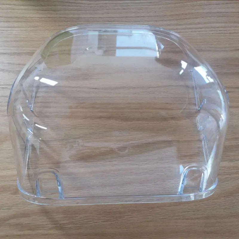 Clear plastic food container with a curved design for easy storage and visibility.