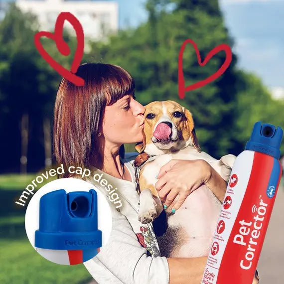 Woman kisses her beagle while holding a Pet Corrector spray can with an improved cap design.