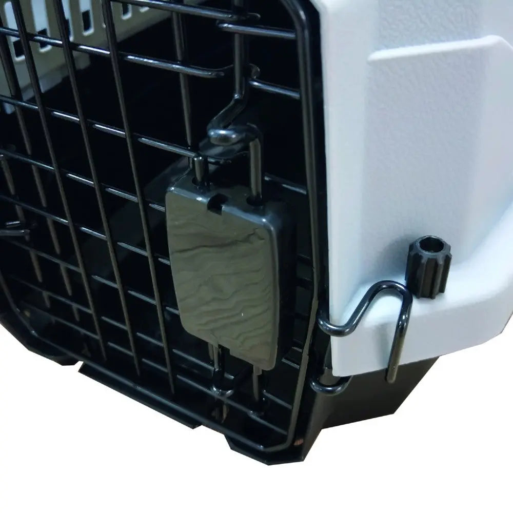Pet carrier with secure latch and sturdy metal grid for safe travel.
