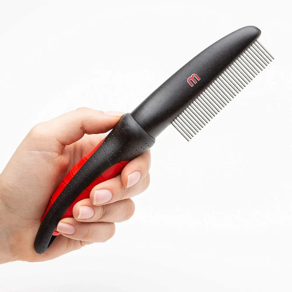 Hand holding a black and red pet grooming comb with fine teeth for effective detangling.