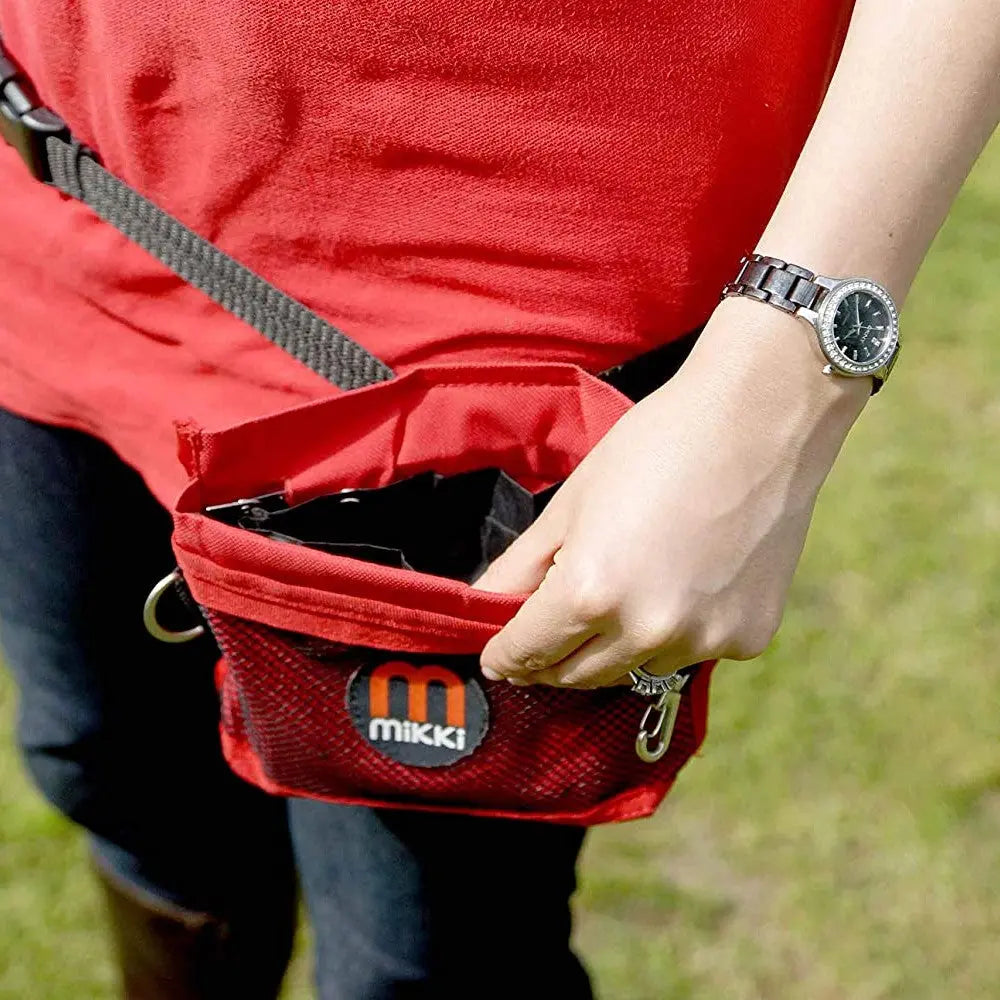 Red Mikki pet accessory pouch for convenient storage during walks or outdoor activities.