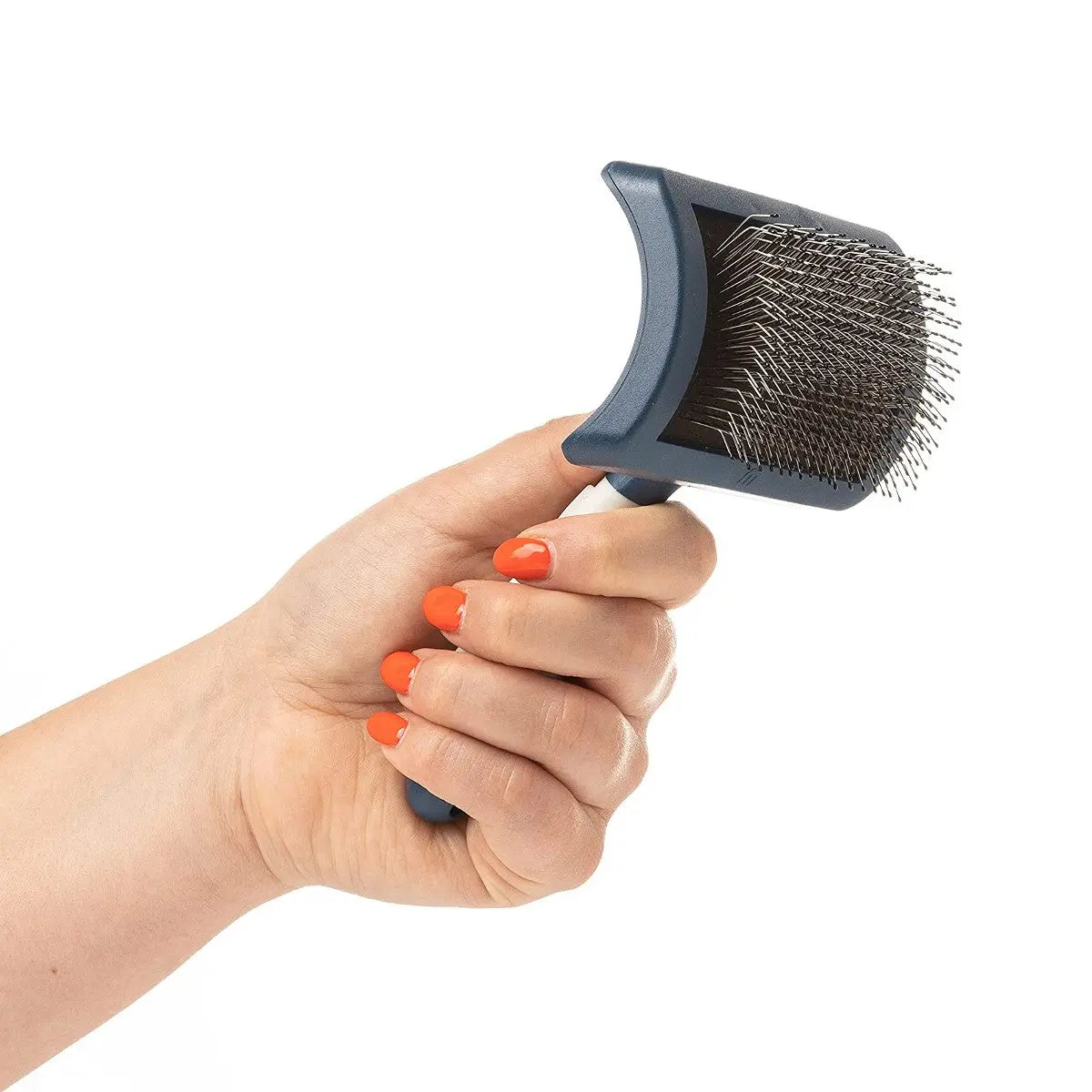 Pet grooming brush for effective fur removal and detangling, held in a hand with bright orange nails.