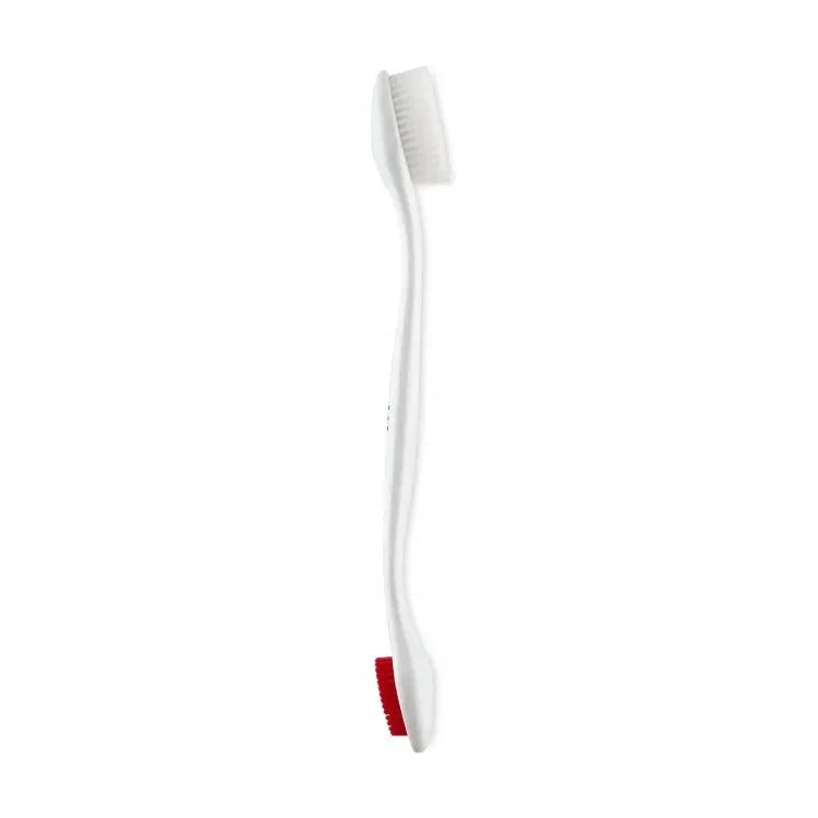 White toothbrush with soft bristles and a red accent for effective dental care.