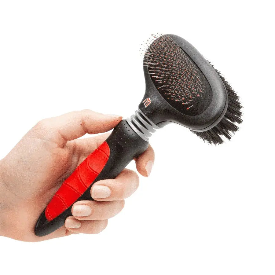 Pet grooming brush with ergonomic handle for effective fur removal and detangling.